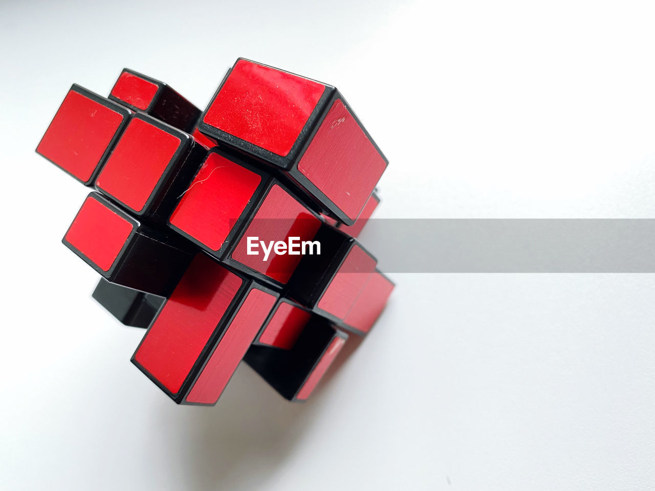 red, rubik's cube, cube shape, mechanical puzzle, white background, studio shot, indoors, font, cut out, toy, no people