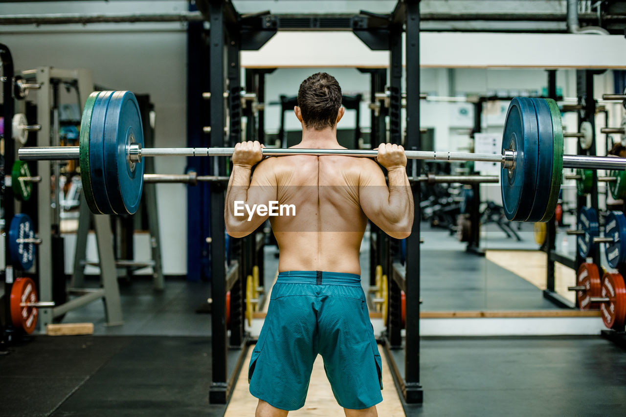 Man weightlifting in front at gym