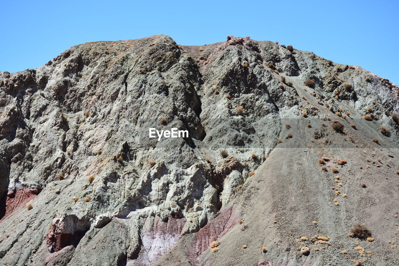 LOW ANGLE VIEW OF ROCK FORMATIONS ON MOUNTAIN