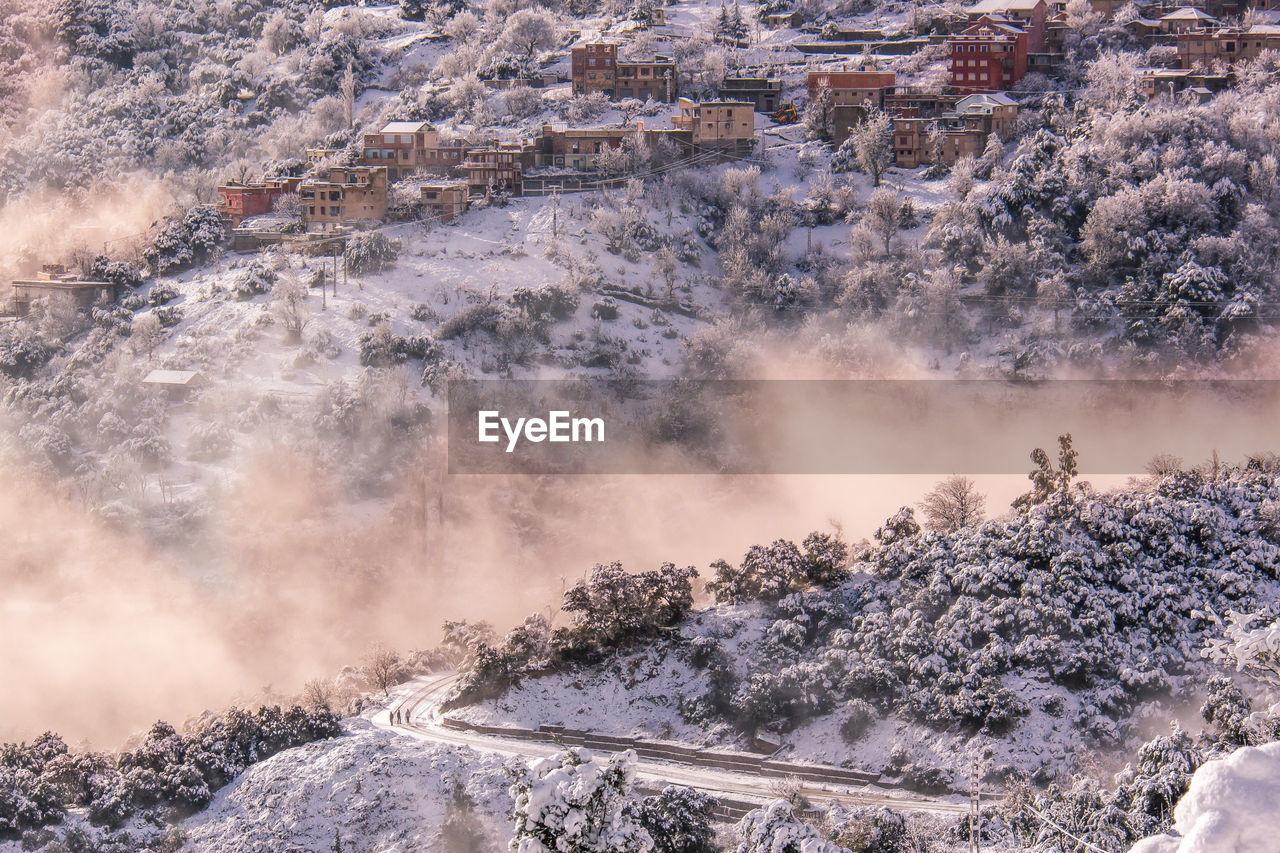 Scenic view of snowcapped landscape in foggy weather