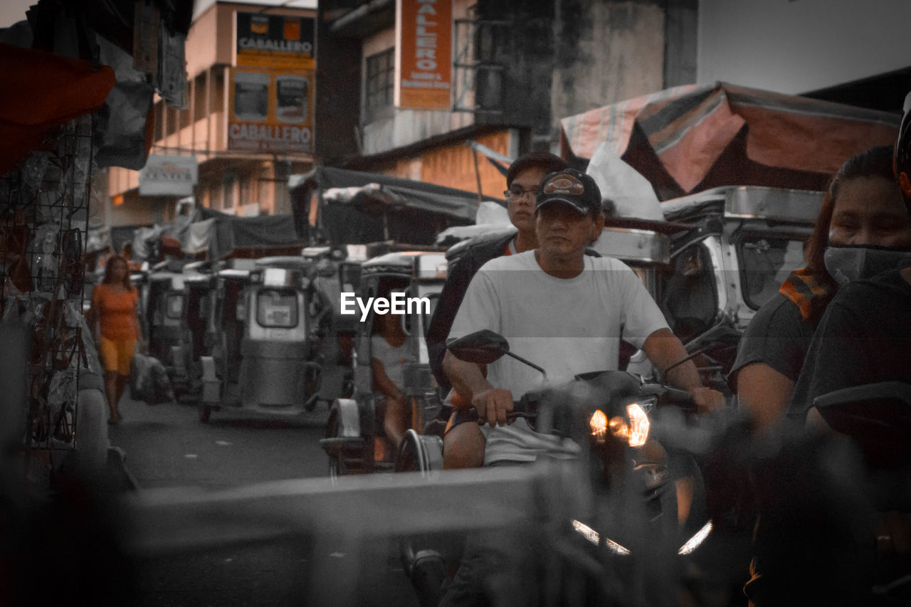 GROUP OF PEOPLE LOOKING AT MARKET