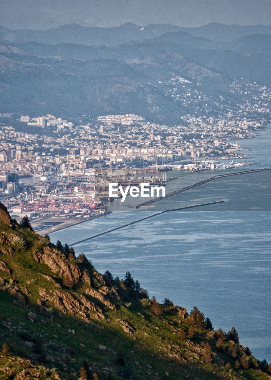 Distant view of the encounter between a mountain slope and the city beyond.