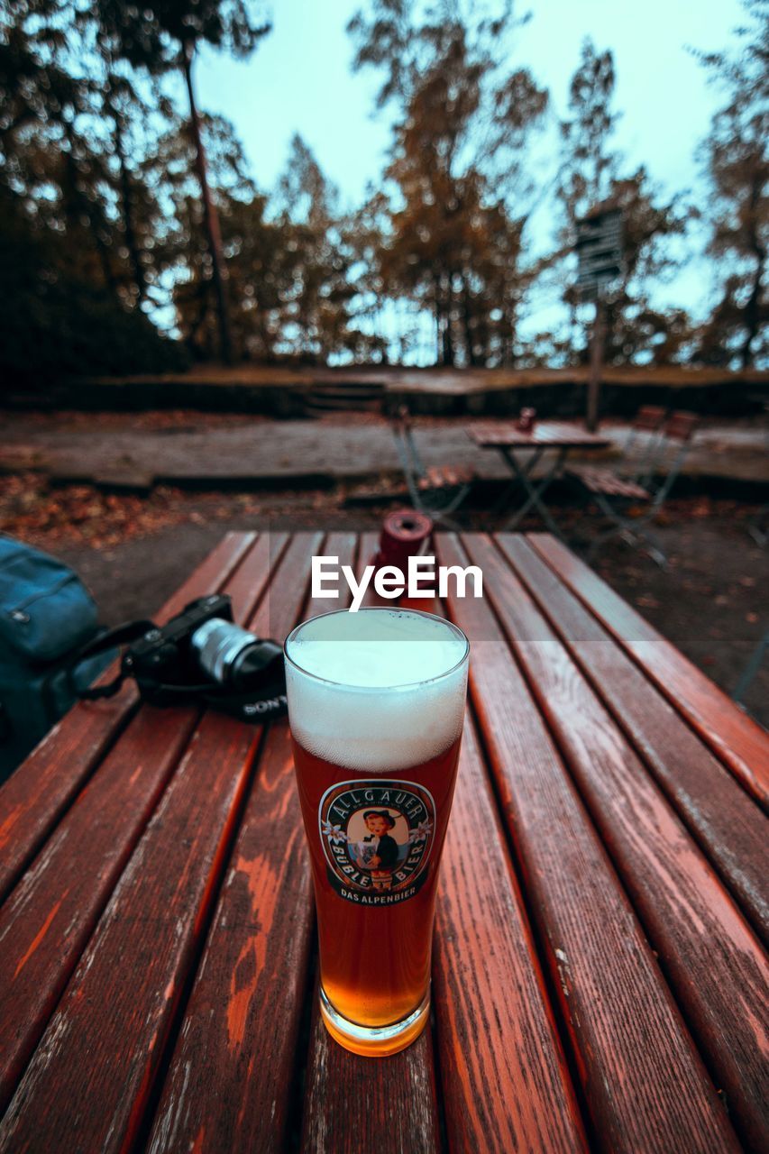 CLOSE-UP OF BEER GLASSES ON TABLE