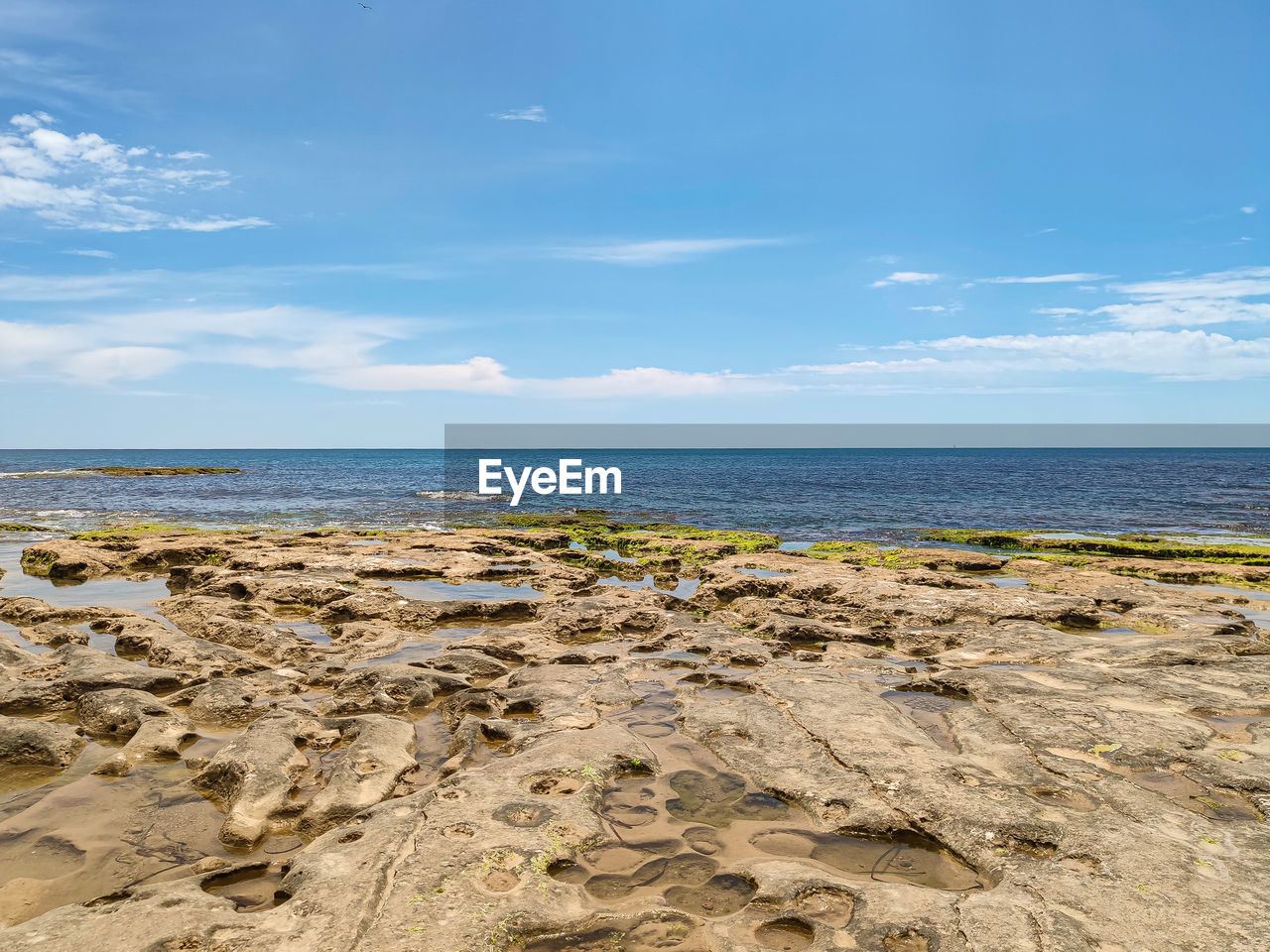 sea, sky, water, land, beach, body of water, shore, scenics - nature, horizon over water, nature, beauty in nature, coast, ocean, horizon, cloud, tranquility, sand, rock, tranquil scene, no people, wave, day, blue, travel destinations, environment, travel, outdoors, natural environment, cliff, terrain, bay, landscape, vacation, tourism, non-urban scene, idyllic, coastline