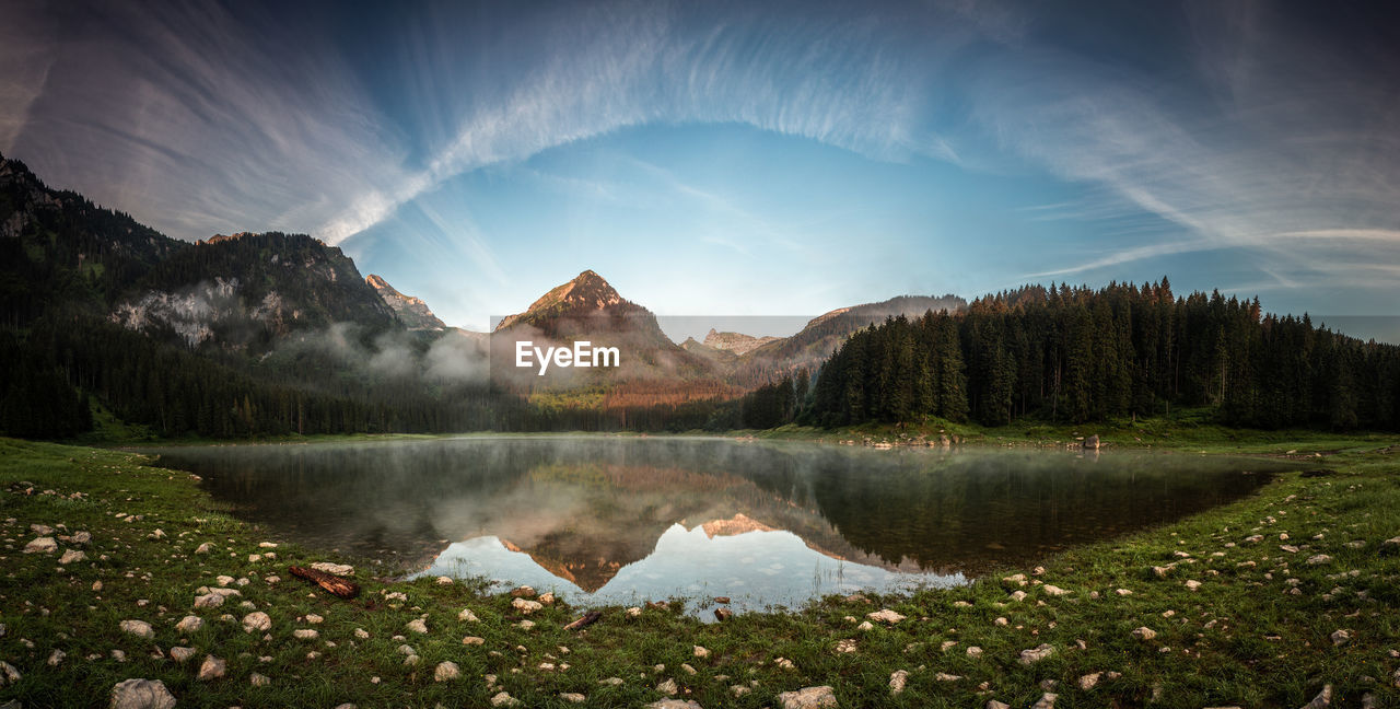 Scenic view of lake and mountains against sky