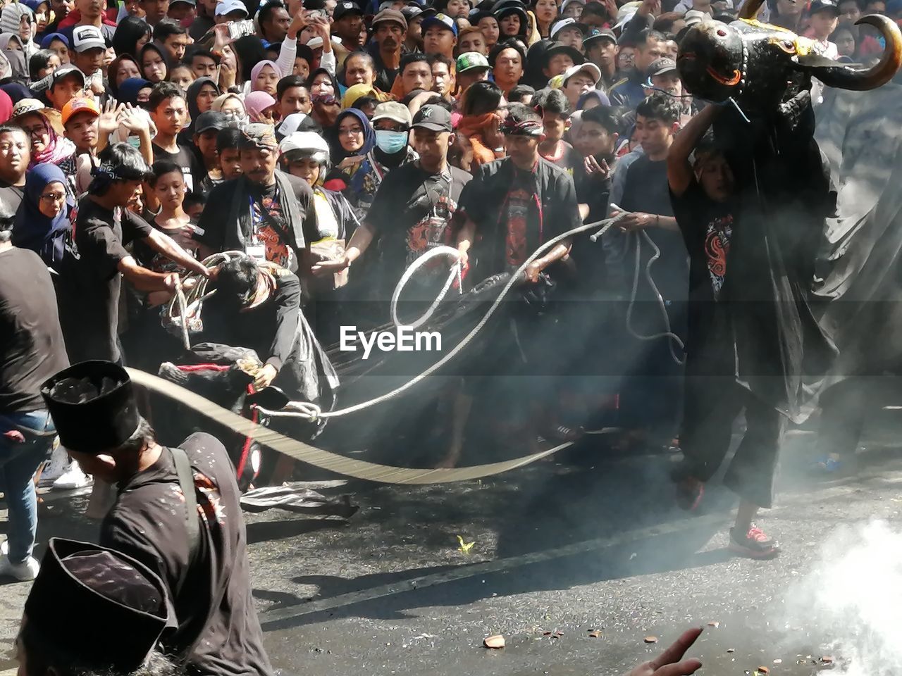 GROUP OF PEOPLE DANCING ON STREET AT MARKET