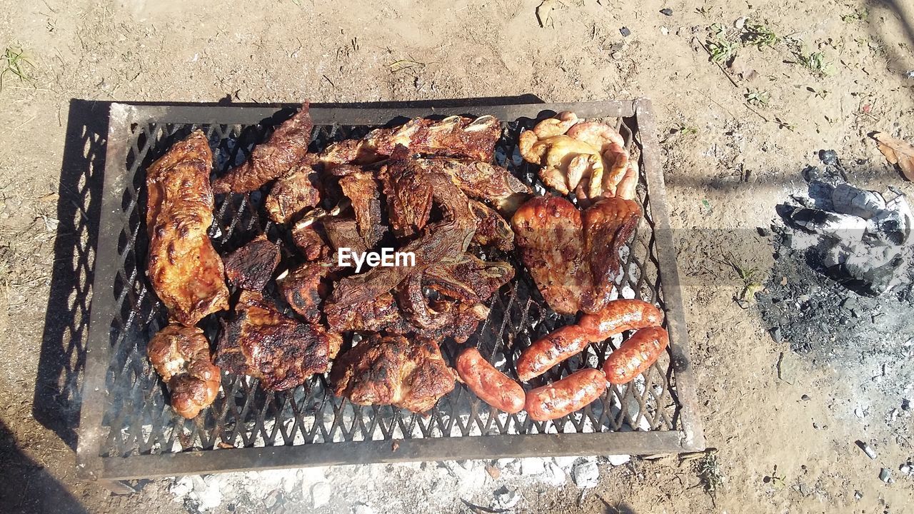 HIGH ANGLE VIEW OF ROASTED MEAT ON BARBECUE