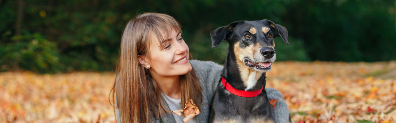 Young woman with dog on field