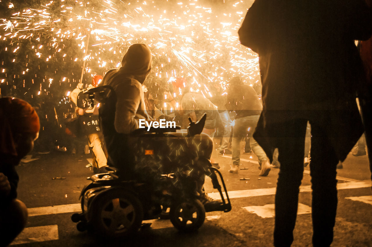 People wearing masks at dragon festival during night