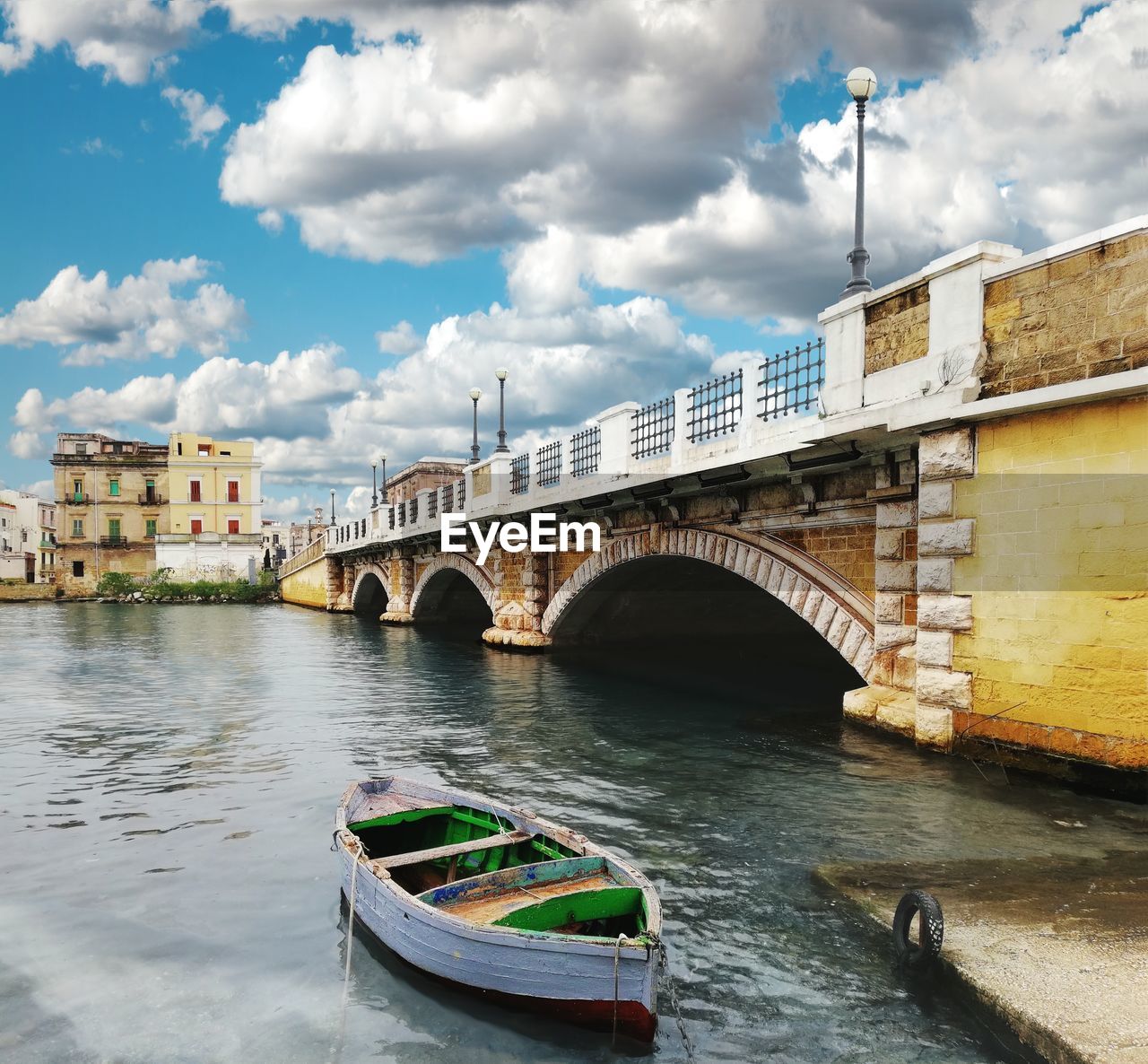 Arch bridge over river against sky