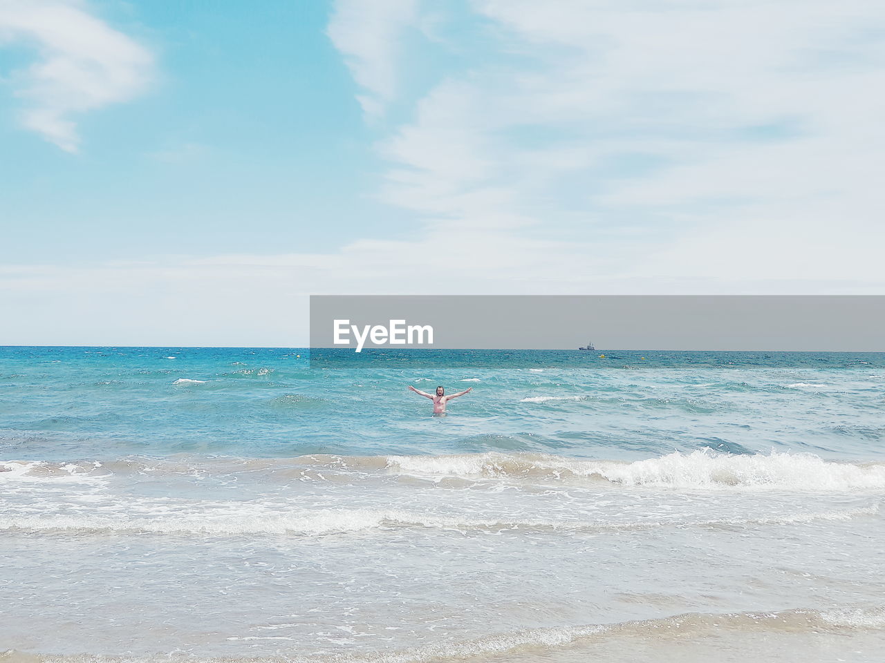 Mid distance of man swimming in sea against sky