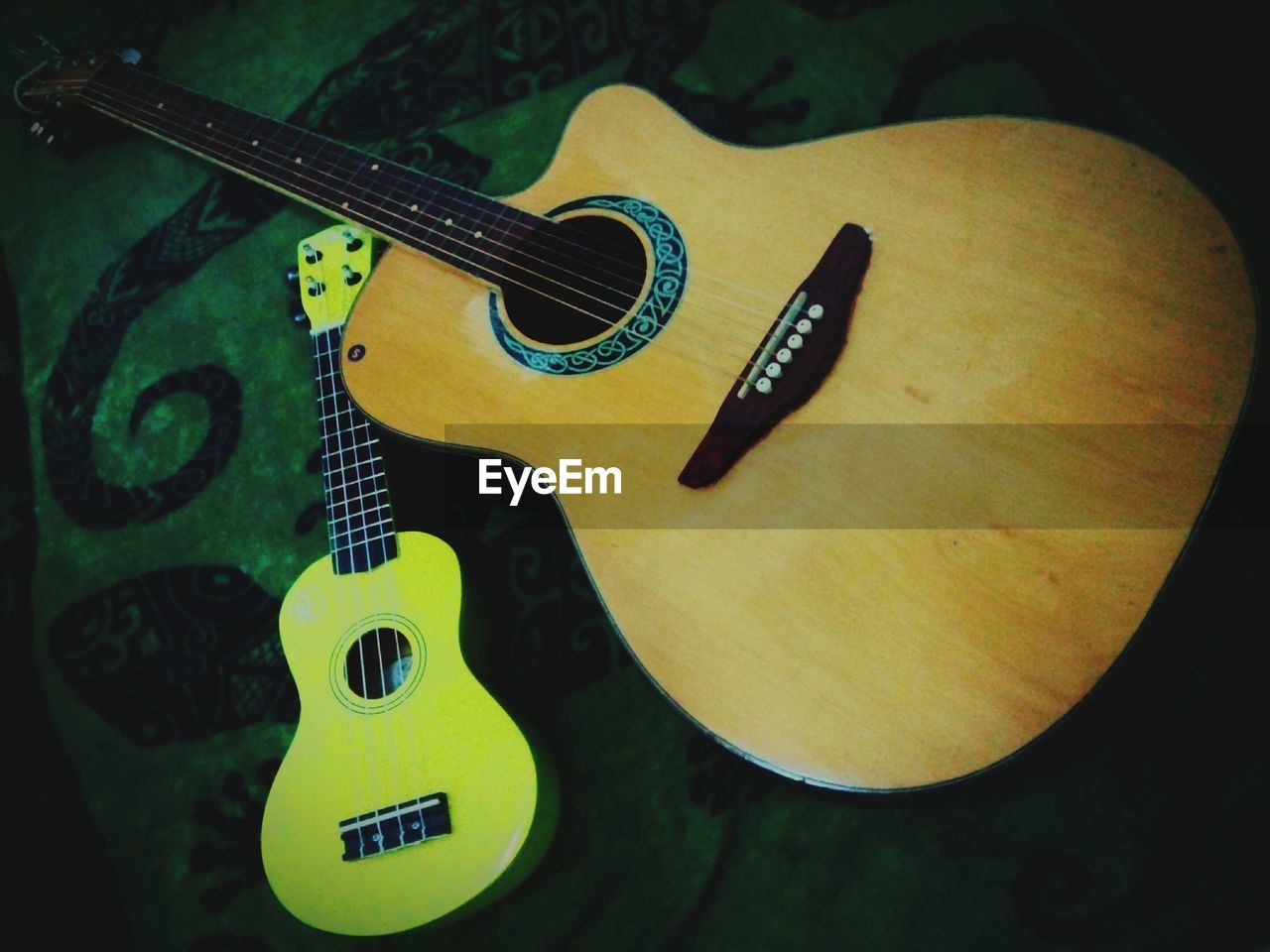 CLOSE-UP OF GUITAR ON CARPET