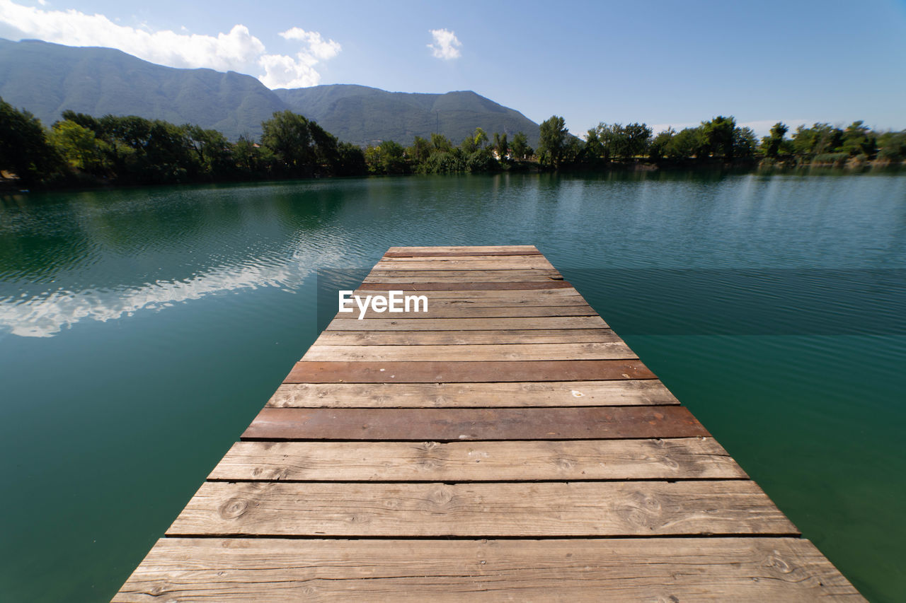 Pier over lake against sky