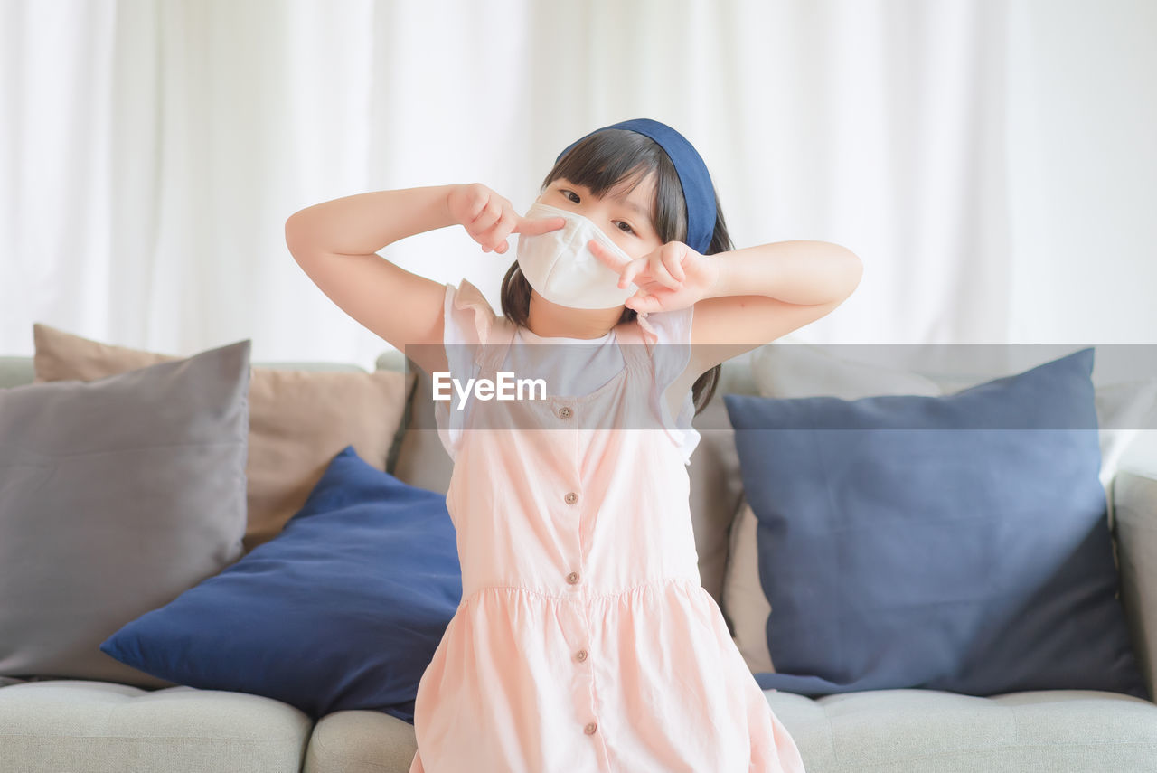 Asian little cute girl wearing hygienic face mask for prevent coronavirus or covid-19 