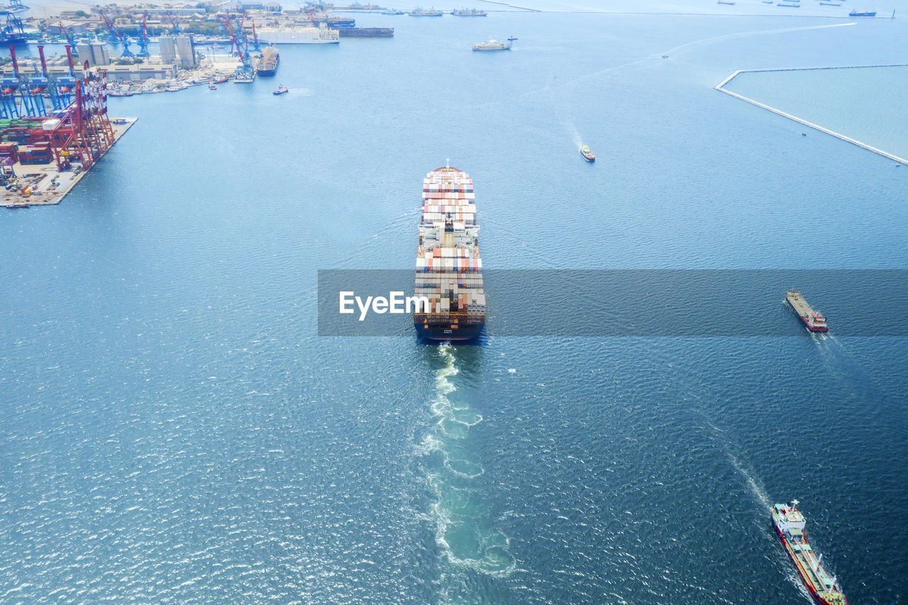 Aerial view of container ship sailing on sea
