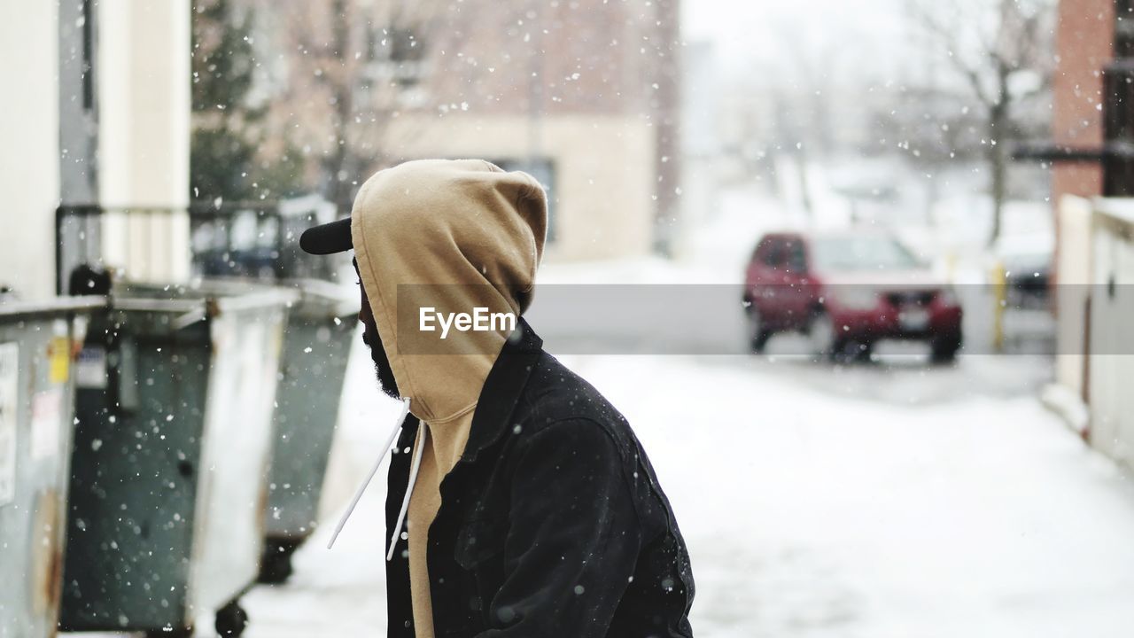 Close-up of man on street during snowfall