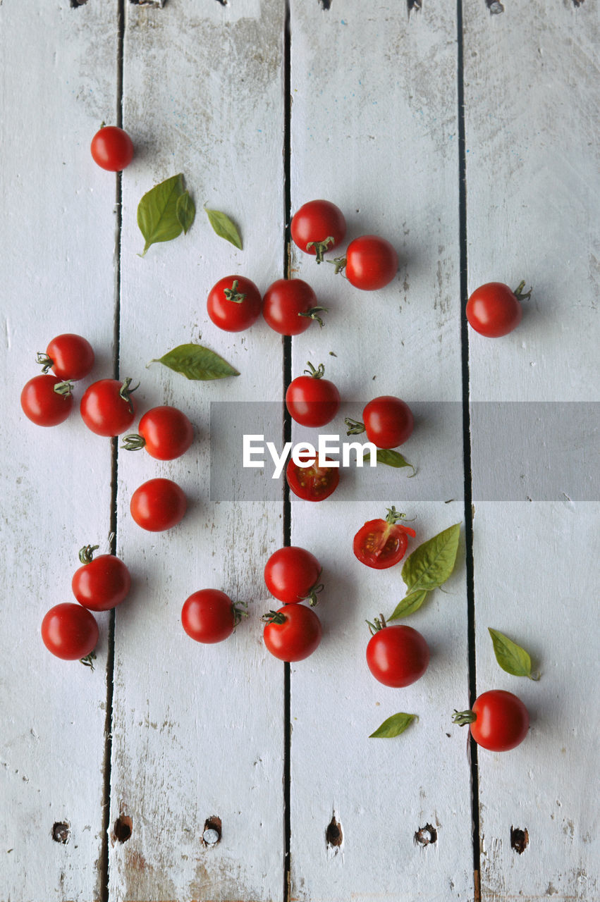 High angle view of cherry tomatoes on wooden background 