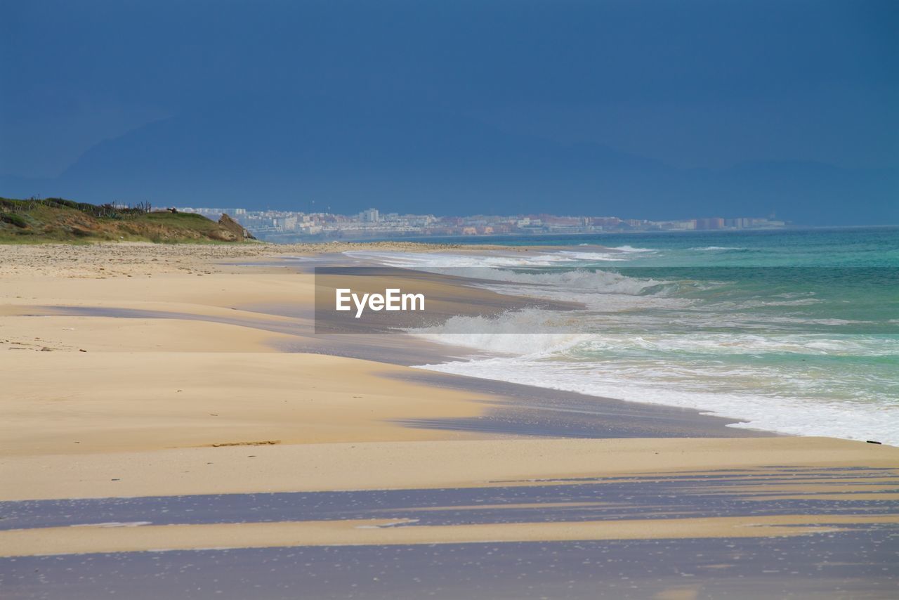 Scenic view of beach against clear sky