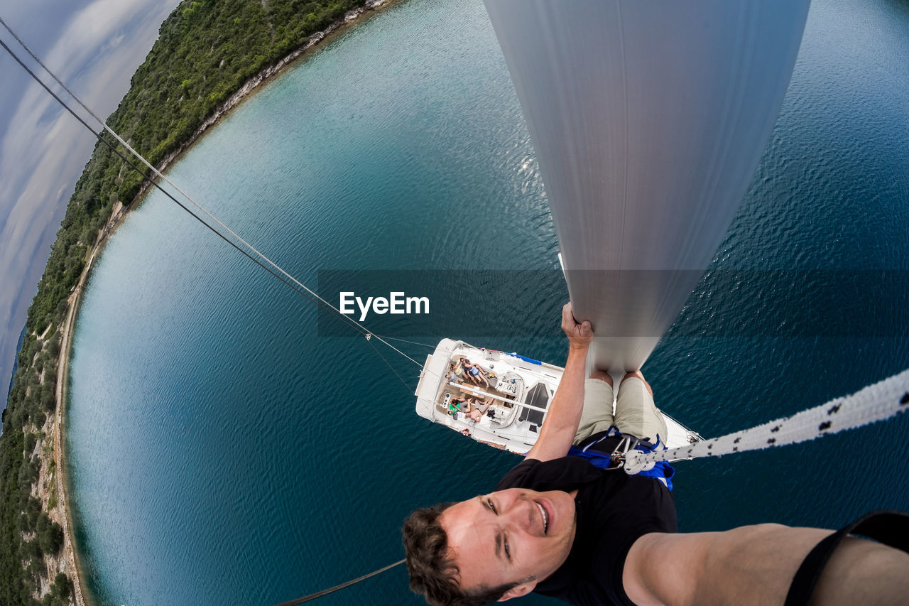 High angle portrait of man in boat on sea