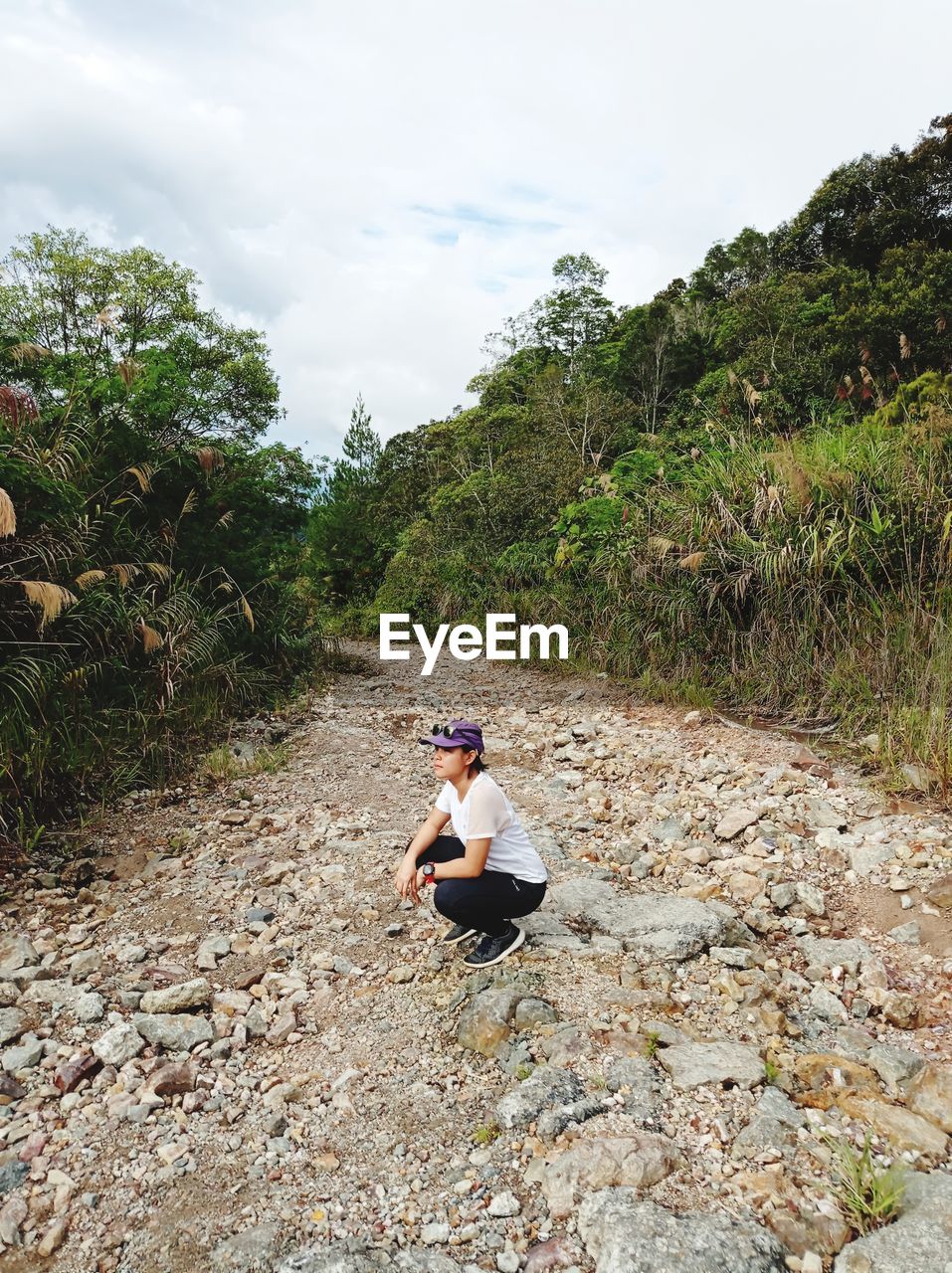 MAN SITTING ON ROCK