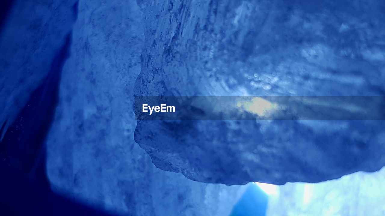 Close-up of snow against blue sky