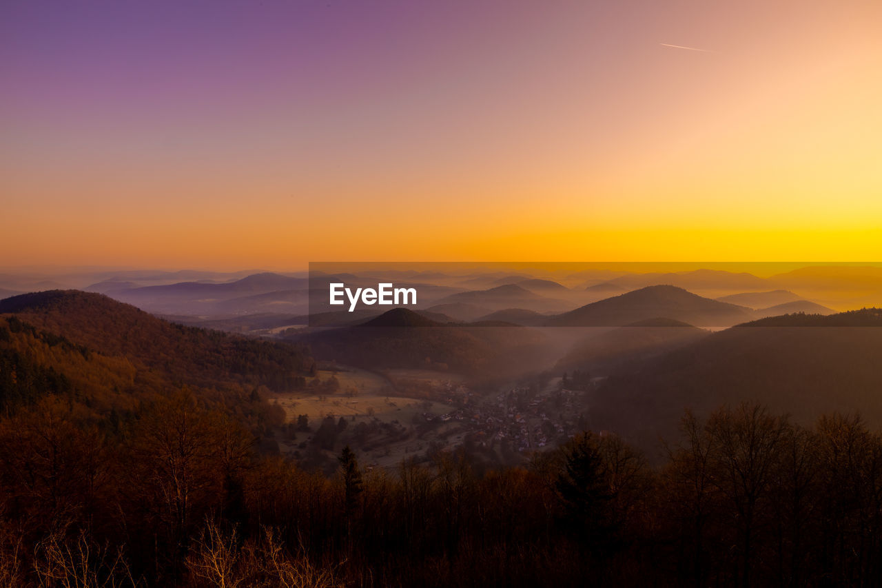 scenic view of mountains against orange sky