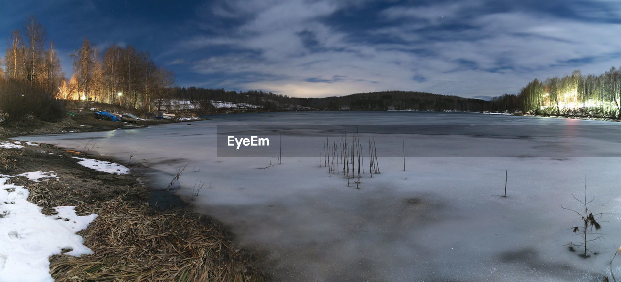 FROZEN LAKE AGAINST SKY DURING WINTER