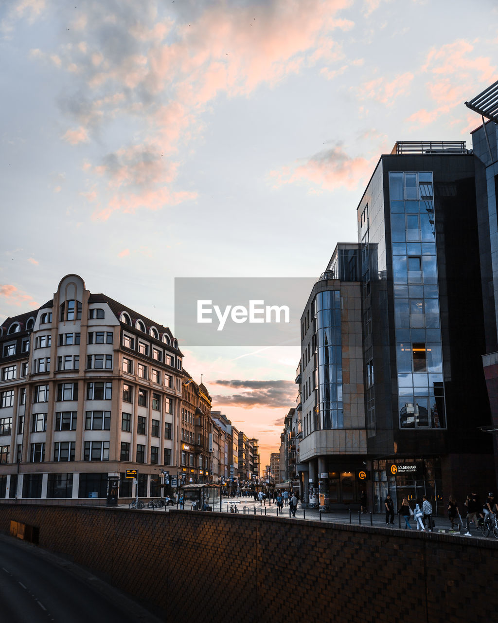 MODERN BUILDINGS IN CITY AGAINST SKY DURING SUNSET