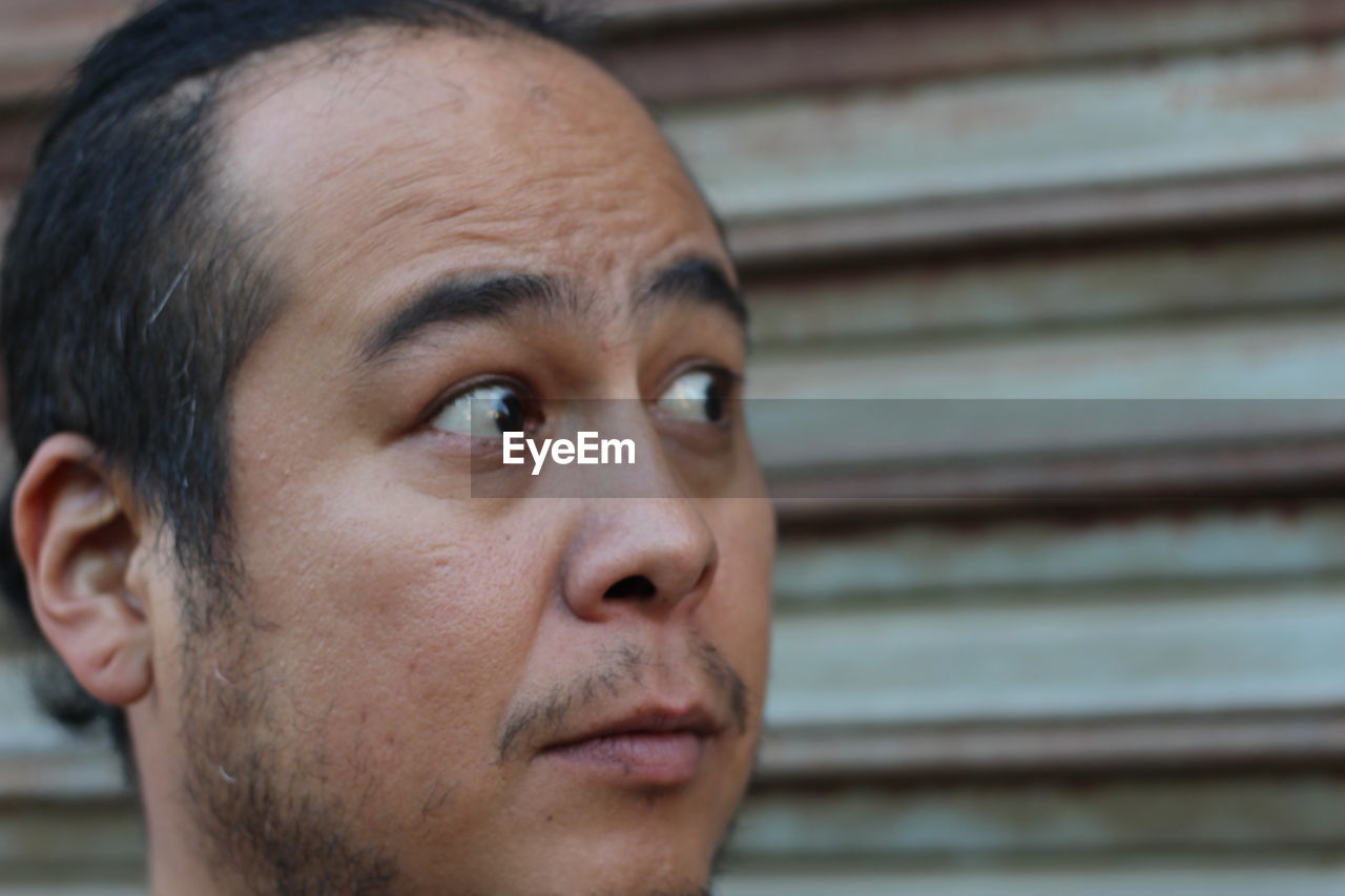 Close-up of man against shutter