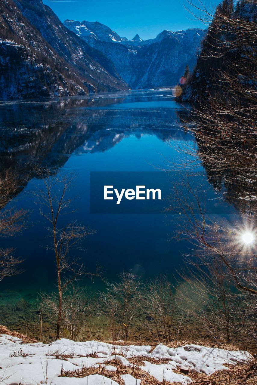 Scenic view of lake and snowcapped mountains during winter