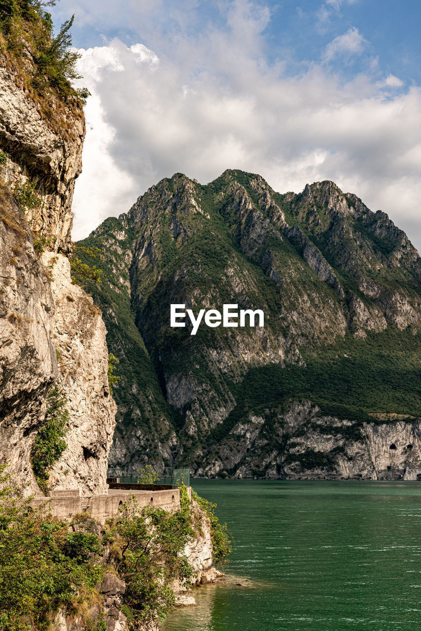 Scenic view of sea and mountains against sky