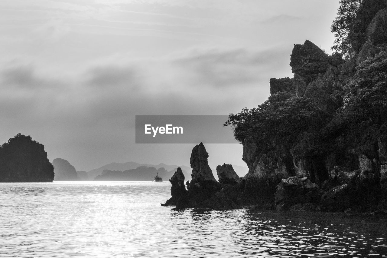 Rock formations in sea against sky