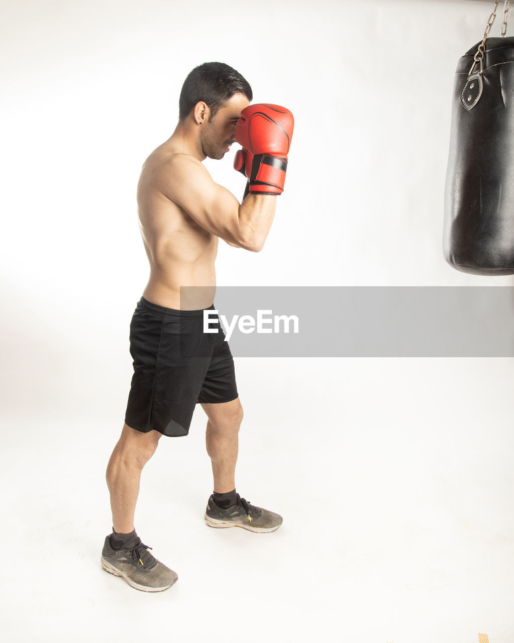 MAN STANDING AGAINST WHITE BACKGROUND