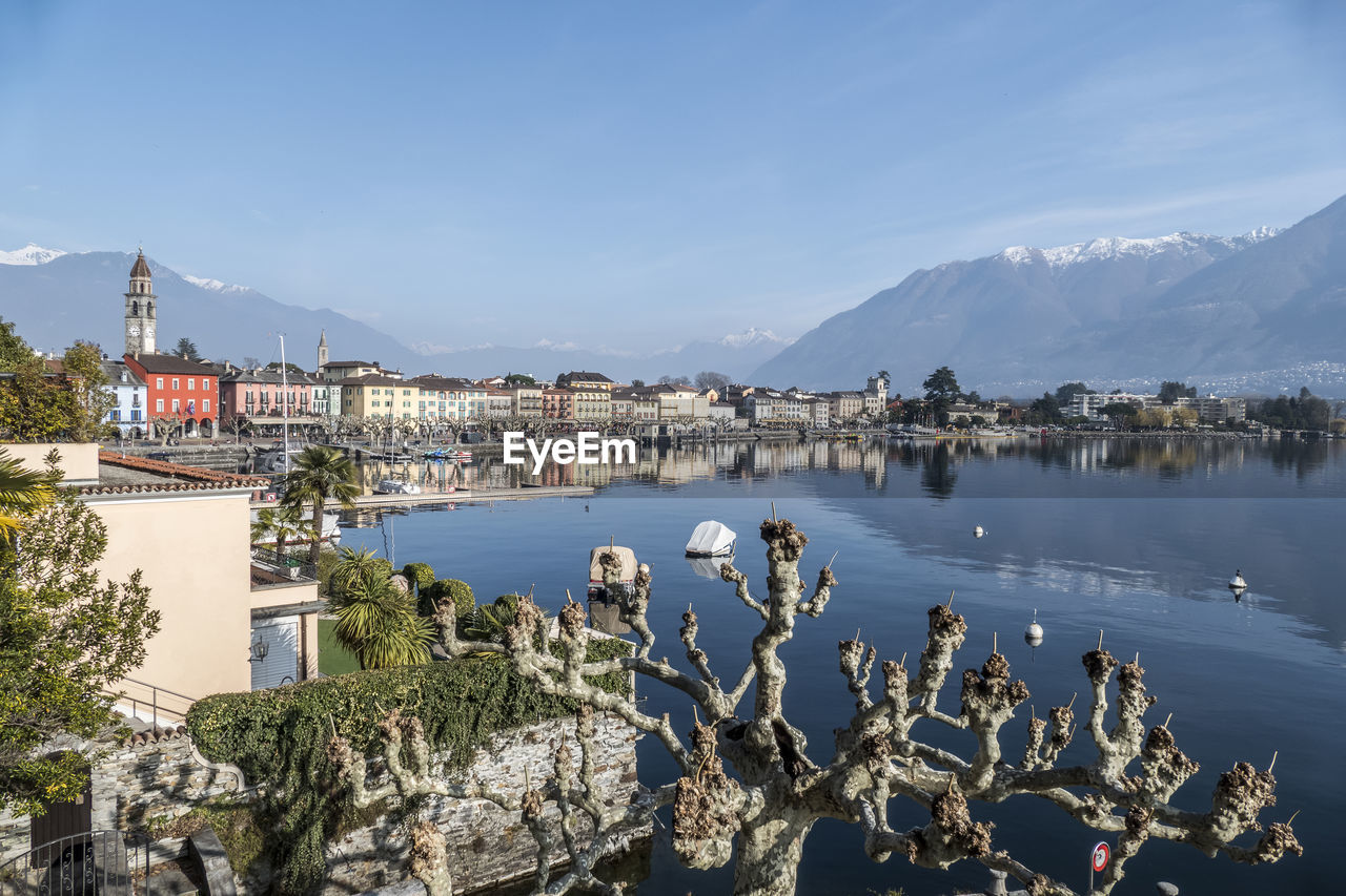  panorama of ascona with houses with colorful facades reflecting on lake maggiore