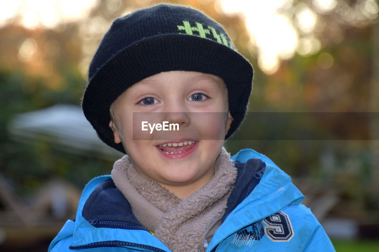 Portrait of smiling boy in warm clothing outdoors