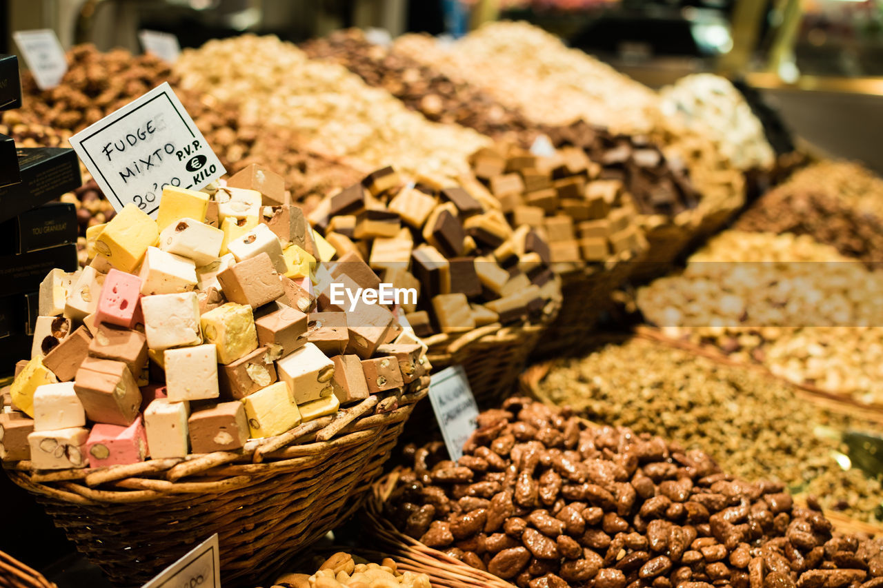 Various sweet food in wicker basket for sale at market stall