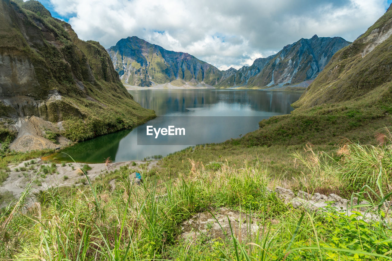 Scenic view of lake amidst mountains against sky