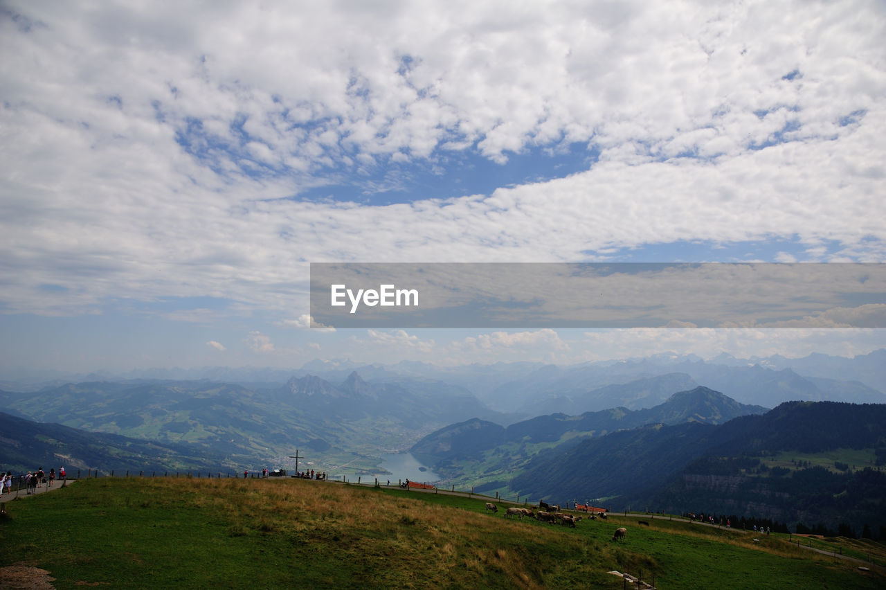 Scenic view of mountains against cloudy sky