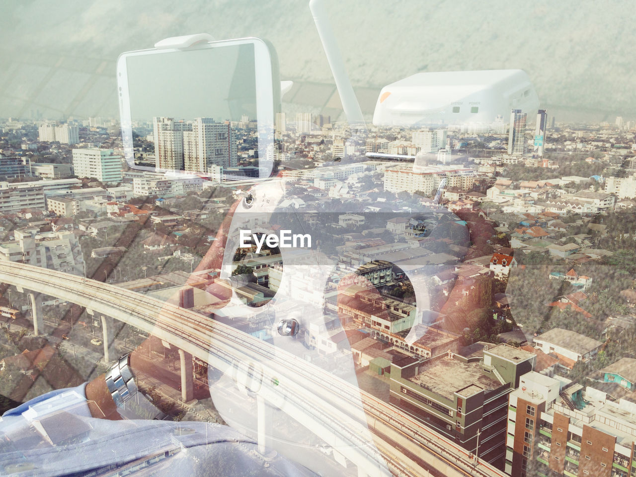 Double exposure of person with drone remote control and cityscape