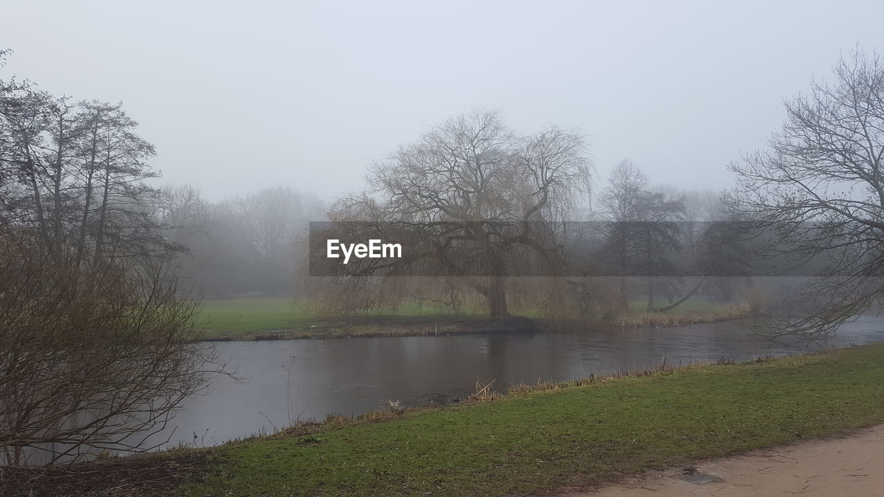 LAKE BY TREES AGAINST SKY