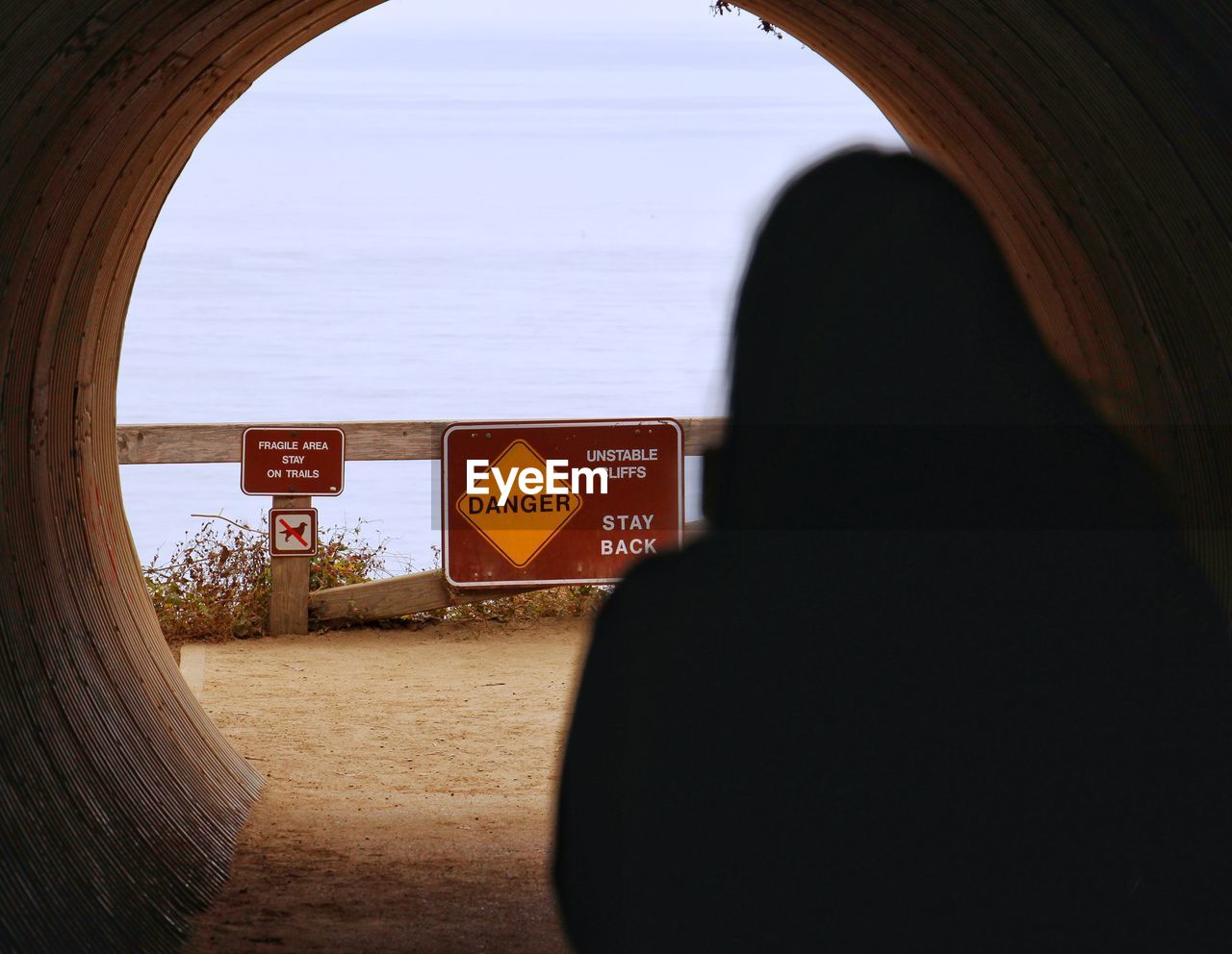 Silhouette of woman in tunnel at the beach