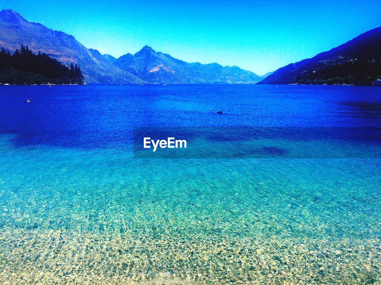 SCENIC VIEW OF LAKE AGAINST BLUE SKY