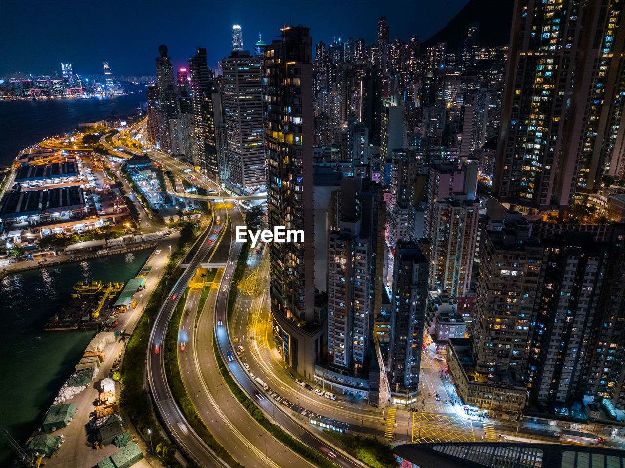 high angle view of illuminated buildings in city at night