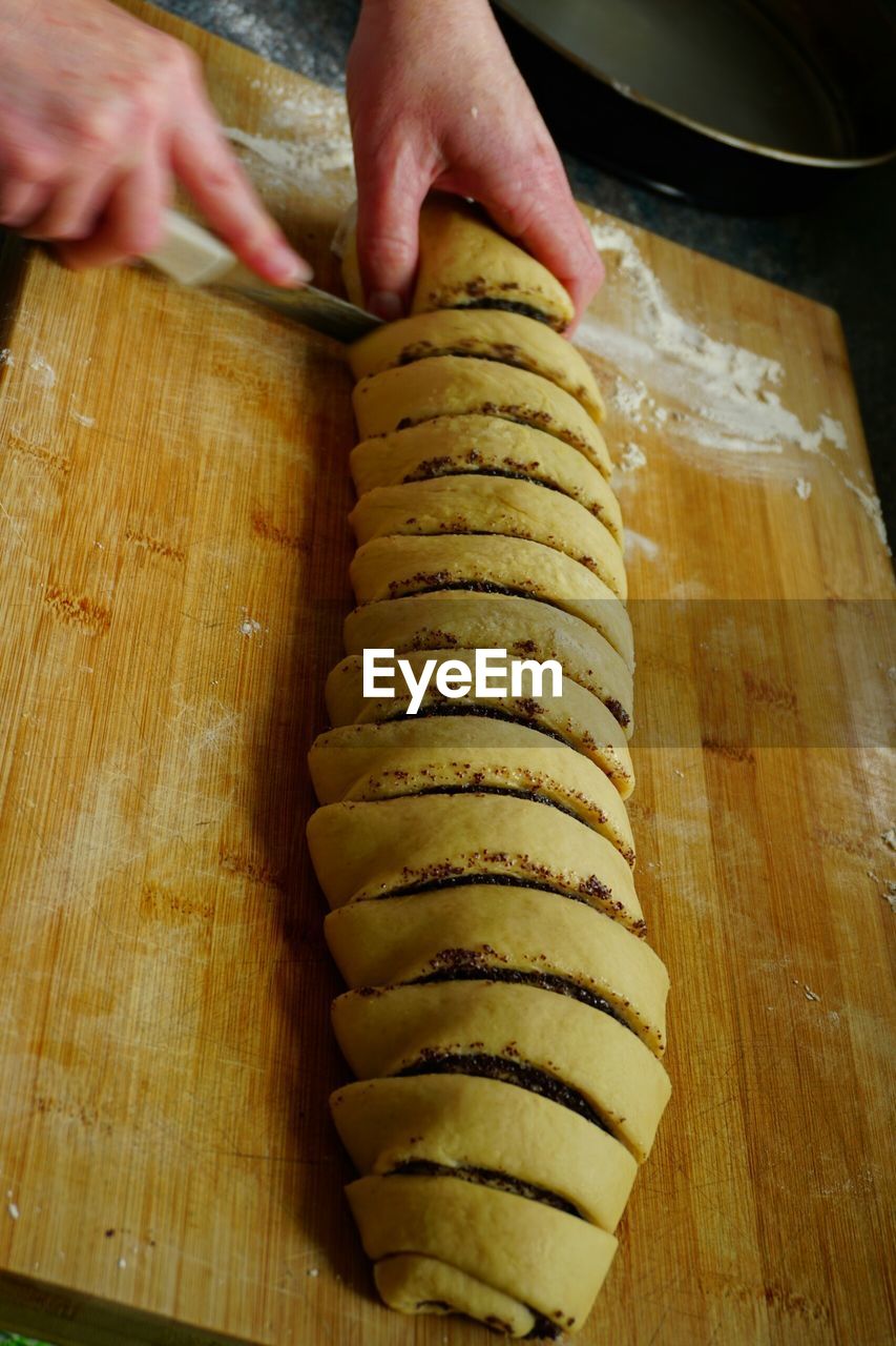 Cropped image of person preparing poppy seed cake in kitchen