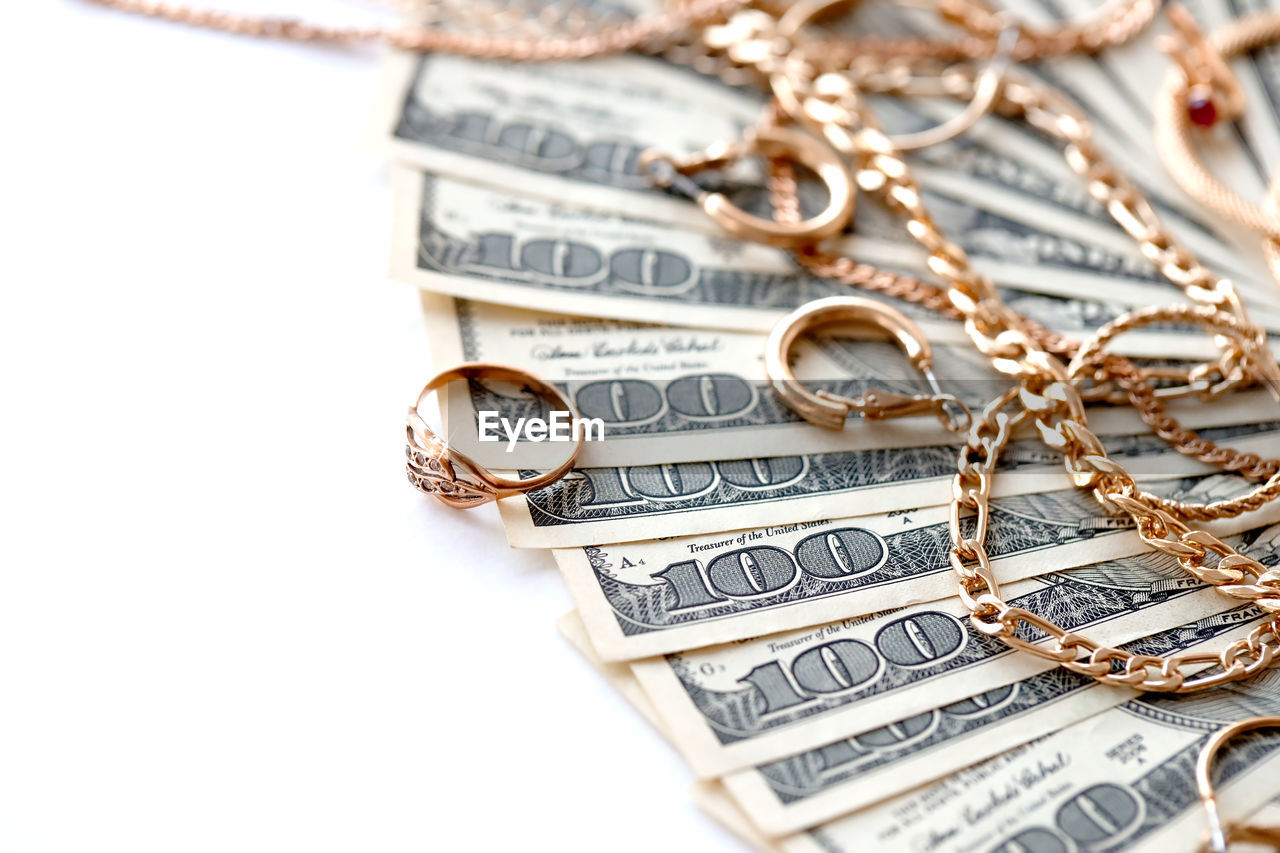 wealth, finance, currency, business, paper currency, chain, cut out, gold, close-up, luxury, studio shot, jewellery, jewelry, copy space, no people, money, savings, abundance, fashion accessory, metal, heap, indoors, large group of objects