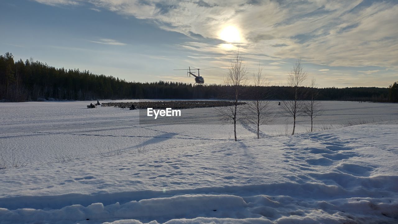 snow, winter, cold temperature, sky, nature, environment, scenics - nature, landscape, tree, beauty in nature, plant, tranquil scene, tranquility, freezing, cloud, land, frozen, no people, non-urban scene, sunset, ice, sunlight, coniferous tree, white, outdoors, forest, field, deep snow, day, pinaceae, sun, rural scene, idyllic, mountain, water