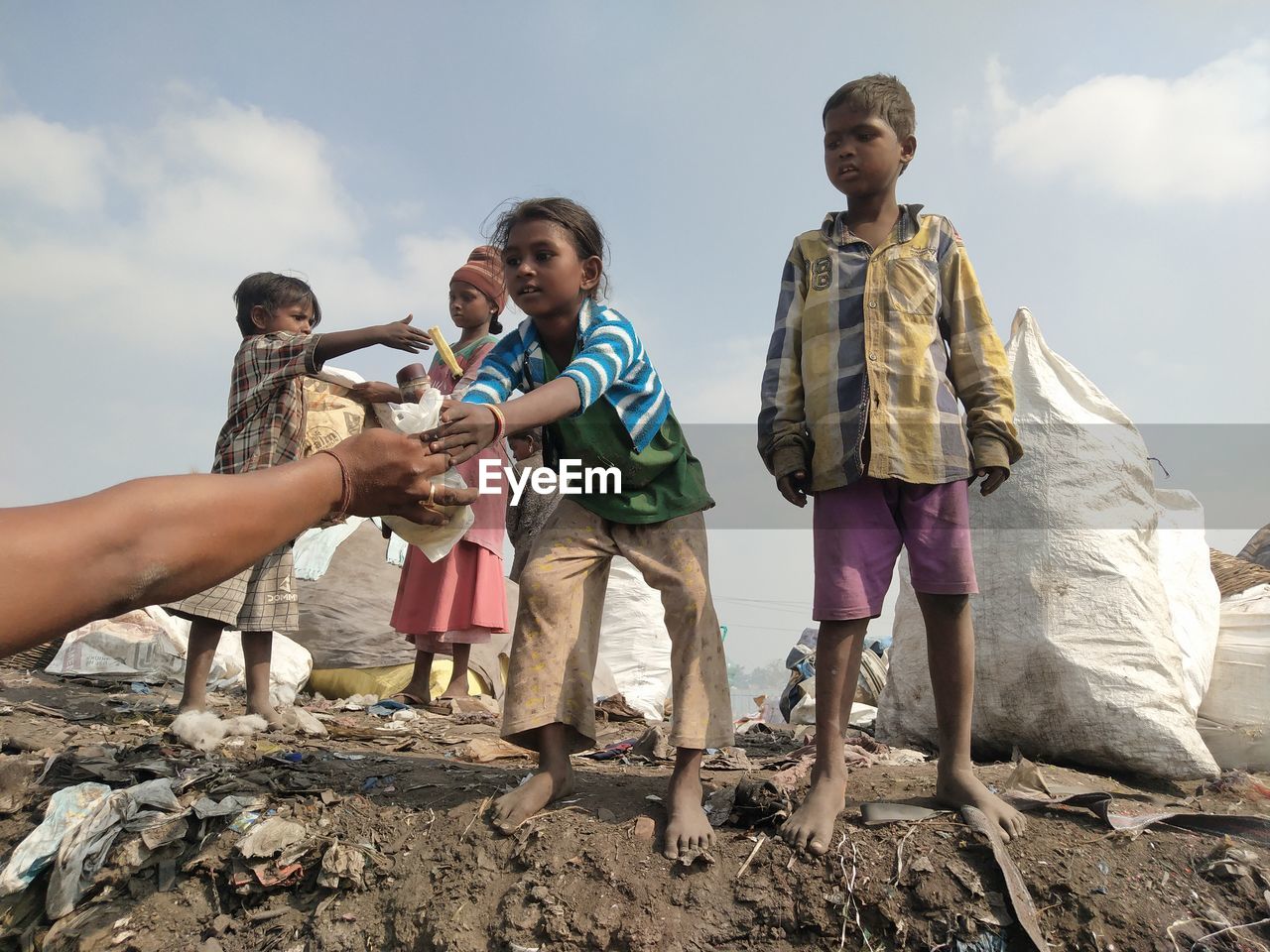 Side view of family standing at dumping yard machilipatnam 