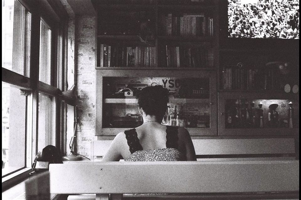 Rear view of woman sitting indoors