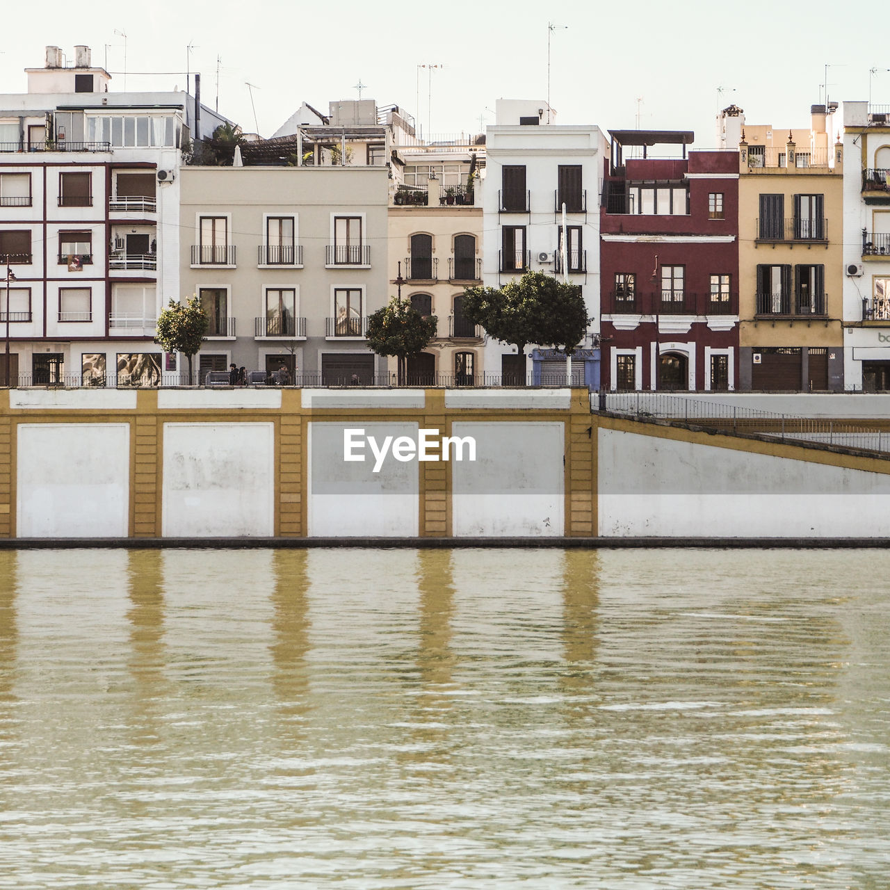 REFLECTION OF BUILDINGS IN RIVER