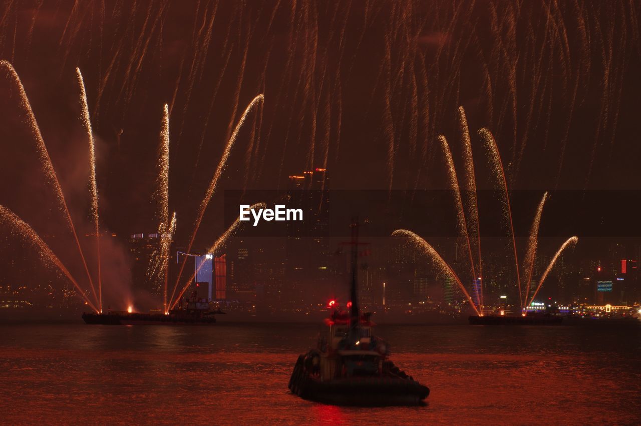 Low angle view of firework display at night